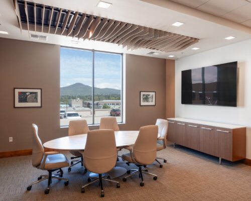 Conference room with custom cabinetry, wood ceiling feature, and downtown Medford views