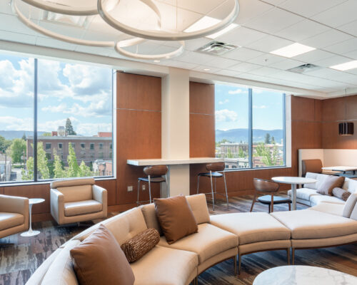 Curved seating area and expansive windows overlooking downtown Medford