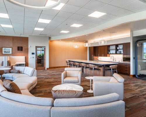 Curved lounge seating beside the kitchen and collaboration area