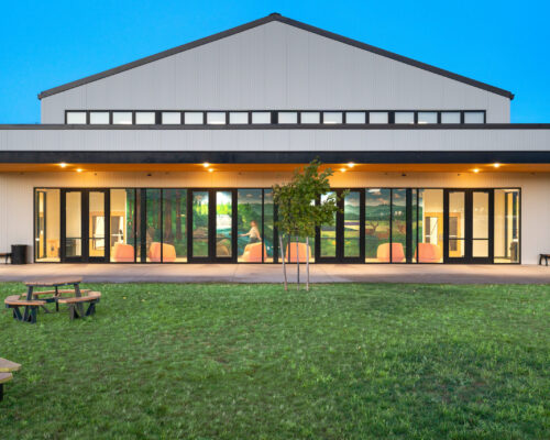Student commons opening onto the lawn and outdoor gathering area