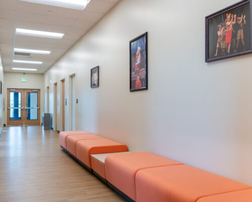 Hallway displaying photographs of student performances at Logos Public Charter School